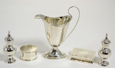 Lot 83 - A pair of silver pepperettes, silver helmet cream jug, silver Victorian snuff box and a silver...