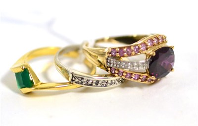 Lot 92 - A 9 carat gold garnet and diamond ring, an oval cut garnet in a claw setting, to a gem set...