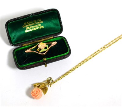 Lot 101 - A 9 carat gold Art Nouveau enamel floral brooch, measures 1.6cm by 3.5cm and a carved coral...