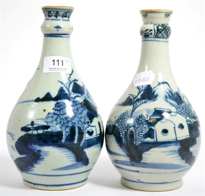 Lot 111 - A pair of Chinese blue and white bottle vases decorated with landscapes