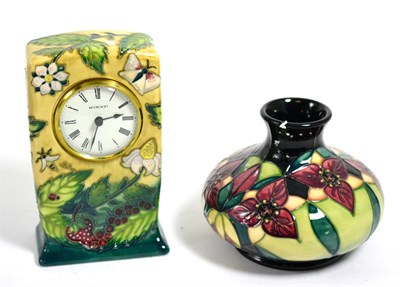 Lot 124 - A Moorcroft pottery timepiece in the Fruit Garden pattern by Nicola Slaney, 16cm and a...