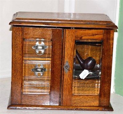 Lot 148 - An early 20th century oak smokers cabinet