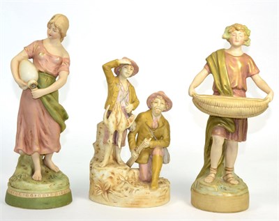 Lot 52 - Three Royal Dux figures; boy, girl and a pair of hunters (3)