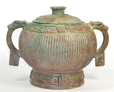 Lot 55 - A Chinese archaic style bronze twin handled vase and cover