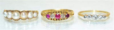 Lot 104 - An 18 carat gold ruby and diamond ring, two round cut rubies spaced by old cut diamonds, in a...