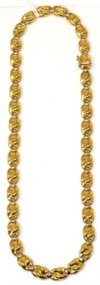 Lot 113 - An Italian necklace, of yellow scroll links alternating with white circular links, length 46cm,...