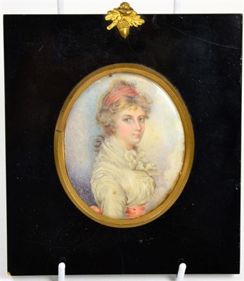 Lot 114 - English School (early 19th century): miniature bust portrait of a young girl, wearing a red...