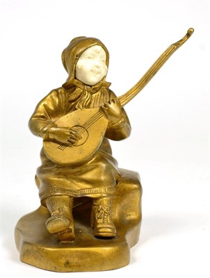 Lot 127 - An early 20th century gilt bronze and ivory figure of a musician
