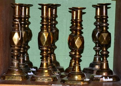 Lot 142 - Five pairs of brass candlesticks