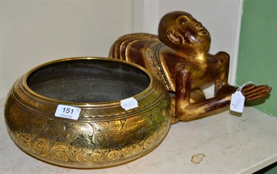 Lot 151 - A Middle Eastern brass bowl and an Indian gilt wood figure of a praying monk