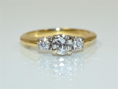 Lot 199 - A diamond three stone ring, a round brilliant cut diamond spaced by two smaller diamonds in...