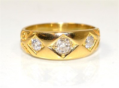 Lot 209 - A three stone diamond ring, star set graduated old cut diamonds, to a tapering shank, total...