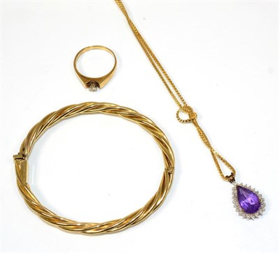 Lot 214 - A 9 carat gold amethyst pendant, a pear cut amethyst within a beaded frame, to a 9 carat gold...