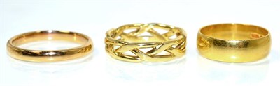 Lot 230 - A broad 22 carat gold band ring, finger size M; a 22 carat rose gold band ring, finger size R...