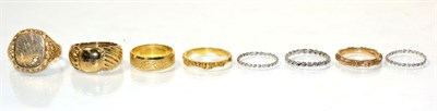 Lot 239 - An 18 carat gold textured band ring, finger size M; a 9 carat gold diamond signet ring, an oval top