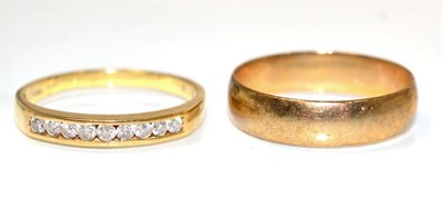 Lot 246 - An 18 carat gold diamond half hoop ring, channel set with round brilliant cut diamonds, total...