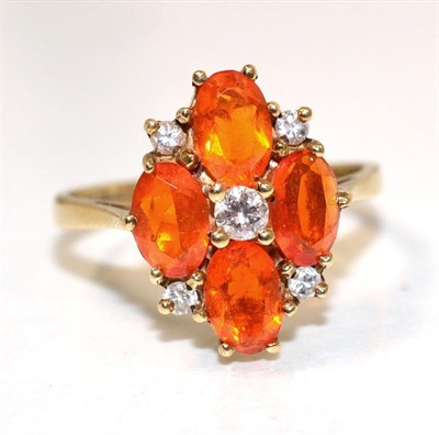 Lot 247 - A 9 carat gold fire opal and diamond cluster ring, a central round brilliant cut diamond within...