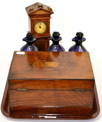 Lot 288 - A 19th century walnut box; a miniature longcase clock and three Bristol blue decanters