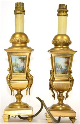 Lot 299 - A pair of gilt metal and painted porcelain table lamps