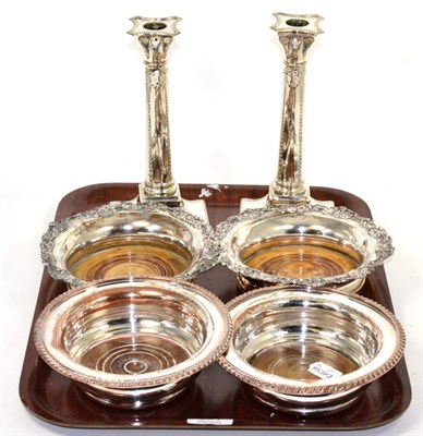 Lot 301 - A pair of plated candlesticks and two pairs of plated bottle coasters