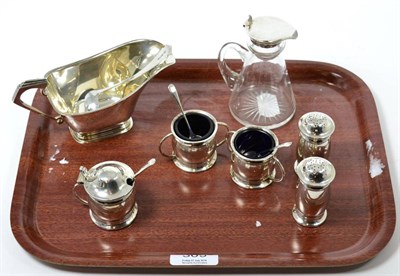 Lot 309 - A silver sauce boat and ladle; a silver mounted whisky noggin and a five piece condiment set