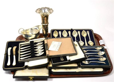 Lot 315 - A cased set of eight silver teaspoons, two cased sets of six silver spoons, a silver sauce boat and