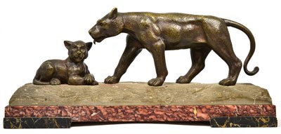 Lot 373 - A bronze stone and marble model of a lioness and cub