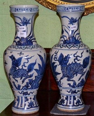 Lot 395 - A pair of early Ming style Chinese porcelain baluster vases