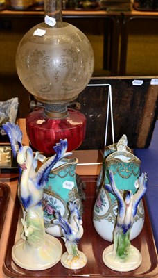 Lot 404 - A Victorian oil lamp with cranberry glass reservoir; with a graduated set of Dutch Jerma birds...