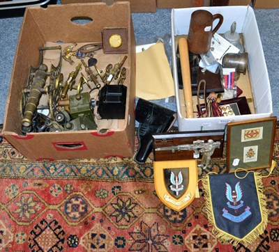 Lot 1104 - Two boxes, including miniature brass cannons, military torches, binoculars, WWII commemorative...