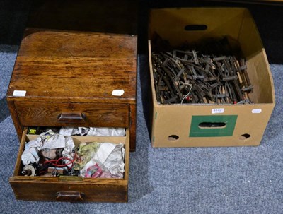 Lot 1142 - An oak two drawer cabinet containing motors and electrical items, together with a box of model rail