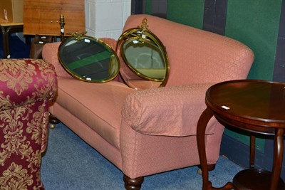 Lot 1145 - A pink upholstered two seater sofa