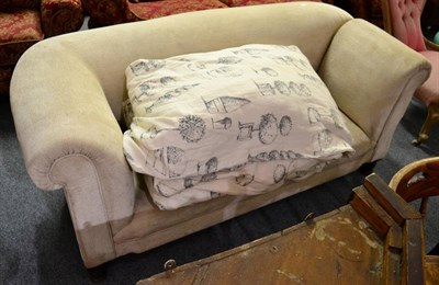 Lot 1176 - A cream upholstered drop end roll top sofa