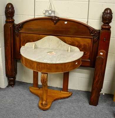 Lot 1197 - A 19th century carved mahogany bed head together with a demi lune marble topped washstand