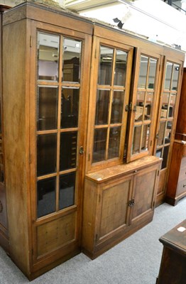 Lot 1217 - A large sectional glazed oak bookcase, early 20th century, with checkered panel cupboard doors