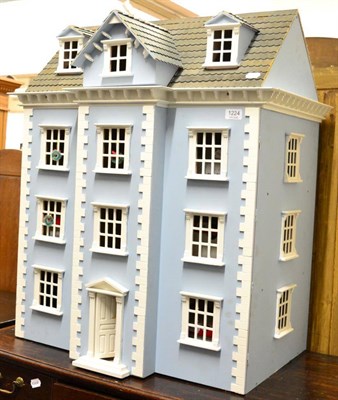 Lot 1224 - A three-storey dolls house, painted and with a large quantity of dolls house furniture