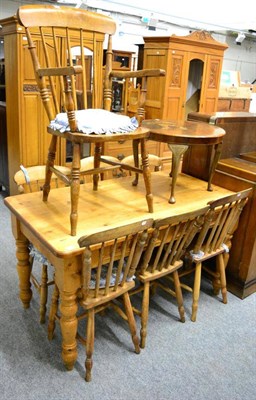 Lot 1229 - A pine kitchen table and six matching chairs together with a further similar armchair and a...