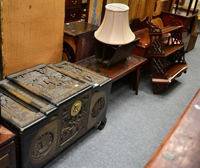 Lot 1232 - A carved Chinese camphor wood chest, carved Chinese coffee table and similar magazine rack (3)