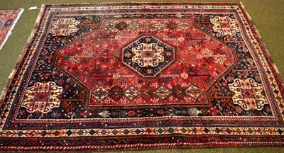 Lot 1265 - A Persian Kashgai rug, South West Iran, the burgundy field centred by an indigo octagon, framed...