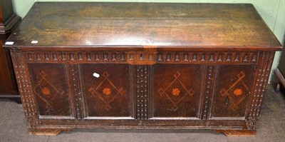 Lot 1277 - An 18th century oak four panelled coffer, carved frieze, inlaid geometric detail