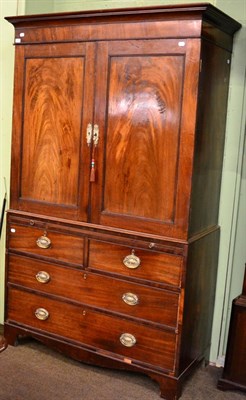 Lot 1279 - A George III mahogany linen press, the upper section fitted with four dressing slides