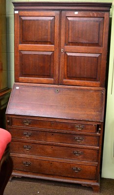 Lot 1280 - A George III panelled oak bureau bookcase