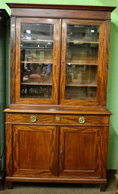 Lot 1283 - A 19th century North European mahogany and brass strung bookcase, the bold cornice over a plain...