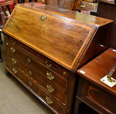 Lot 1299 - A George III crossbanded mahogany bureau