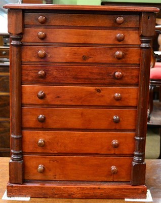 Lot 1312 - A miniature stained pine wellington chest