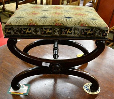 Lot 1320 - A Regency mahogany dressing table stool with needlework seat and X form legs, joined by a...