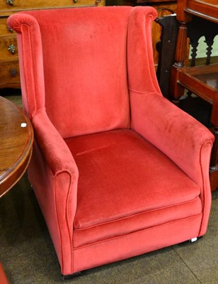 Lot 1322 - A 1920s red upholstered wing chair