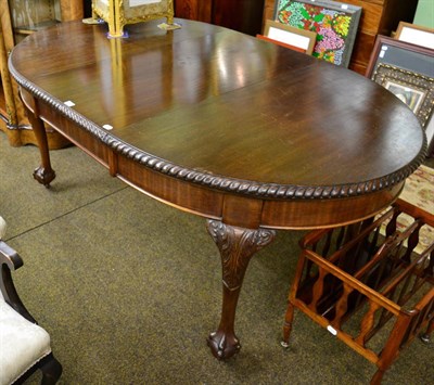 Lot 1326 - A mahogany wind out dining table with gadrooned border and raised on ball an claw feet, moving...