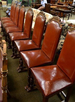 Lot 1332 - A set of eight oak and leather dining chairs