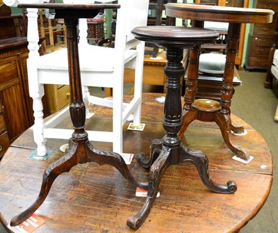 Lot 1365 - A 19th century carved oak tilt top wine table together with a carved mahogany dish topped torchere